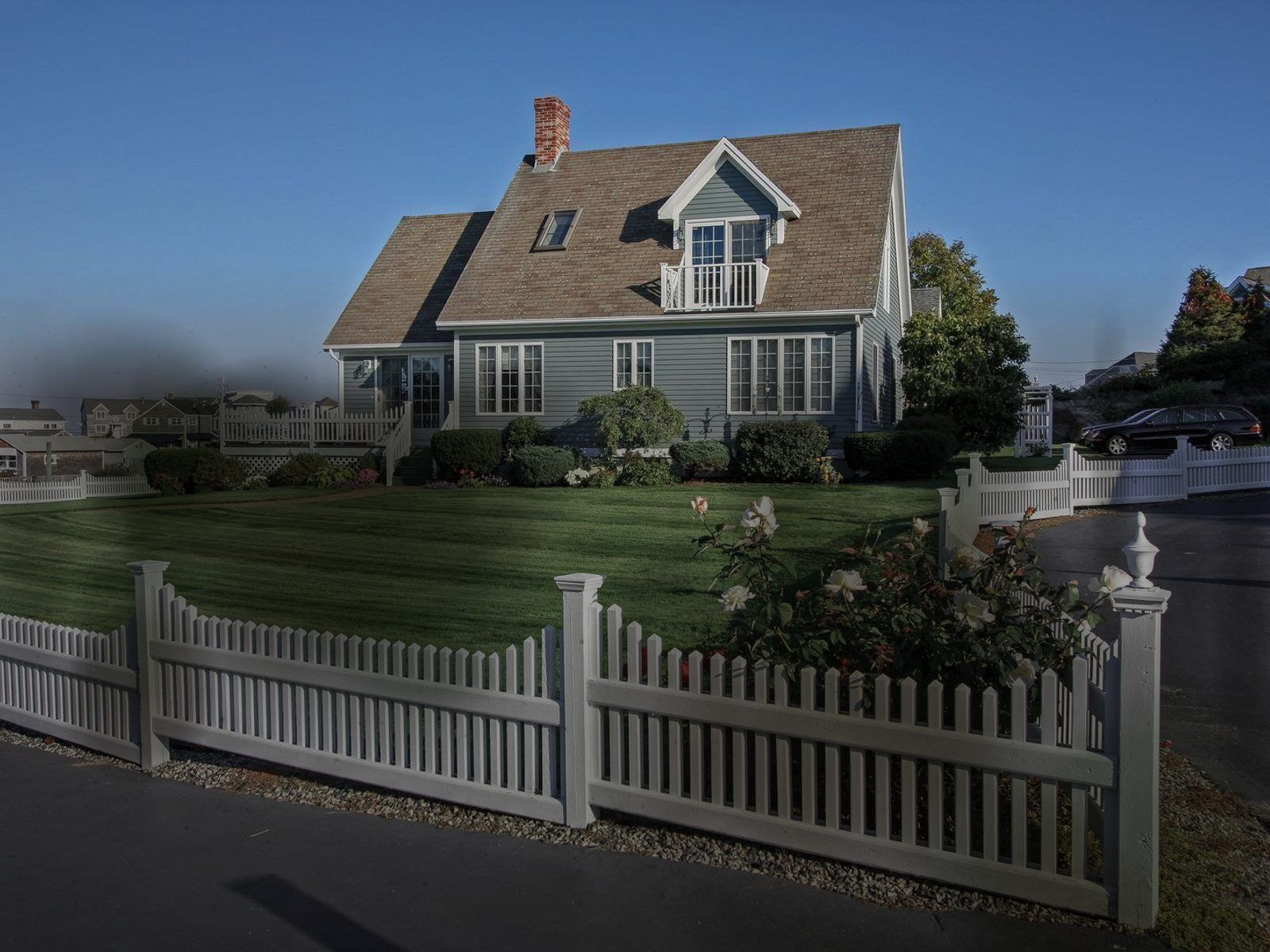 White fence — green film gone — before cleaning